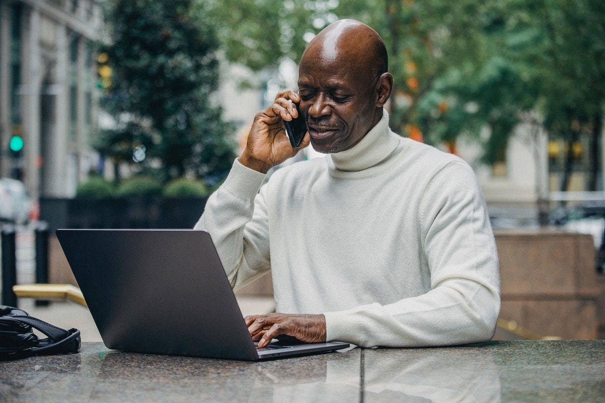 man-phone-laptop-outdoors